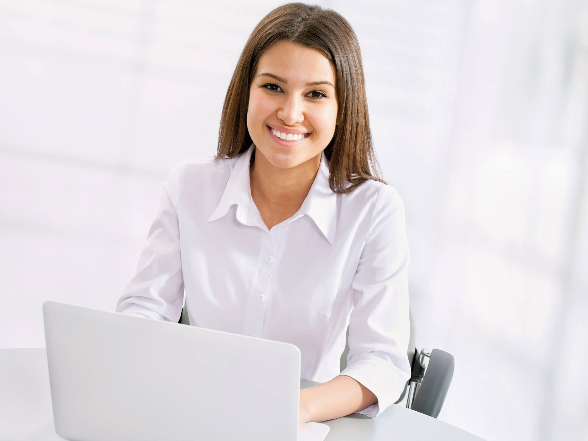 Woman, office, computer work, laptop, smiling, serious, business